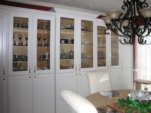 Wall to wall built in china cabinets with glass doors.