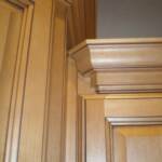 This view shows why most crafstman today don't spend the extra time needed to correctly trim the cabinets adjacent to a staggered corner cabinet.  Two fillers are required for each double crown return and the idea is to not see them.  The scribe moulding then has to be scrolled to fit the crown.